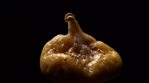 Dry figs in rotation on black background. Stock Footage 99583423
