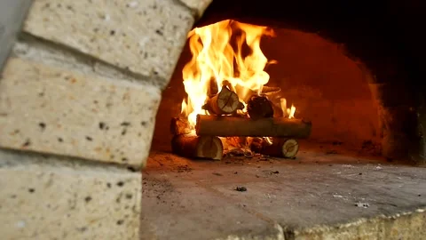 Dry firewood stacked in rectangular bright flames burns in a stone oven to heat  스톡 동영상 237333514