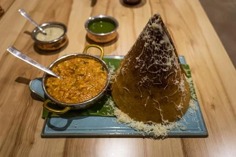 Dry flatbread in shape of a cone and various types of sauce on the table in.. Stockfoto's