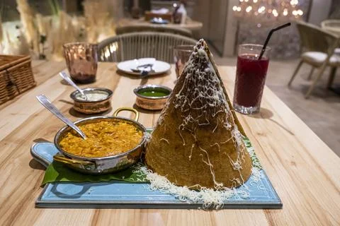 Dry flatbread in the shape of a cone and various types of sauce on the table  Stock Photos