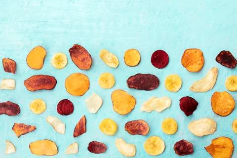 Dry fruit and vegetable chips, shot from the top on a blue background with a 写真素材