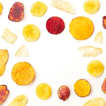 Dry fruit and vegetable chips, an organic food flat lay on a white background Stock Photos