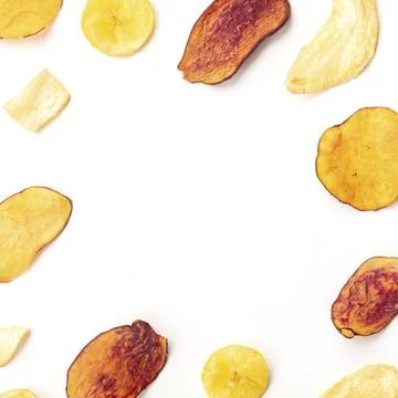 Dry fruit and vegetable chips on a white background, forming a frame for copy Stock Photos