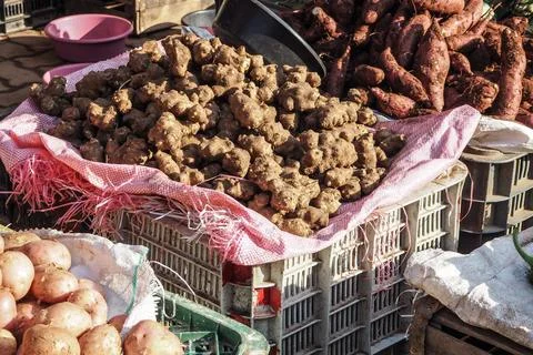 Dry ginger roots in plastic crate displayed on street market in Morocco Stock Photos
