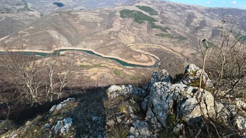 Dry grass and bare trees dot the rocky hillside. Balkan, Eastern Europe, POV Vídeo Stock 331813599