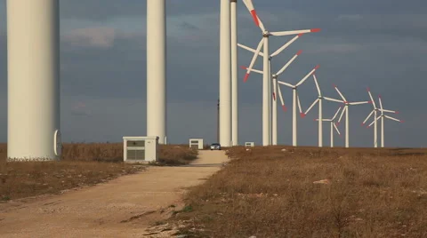 Dry grass Chrysler300 tarmac road windy windmills3545 스톡 동영상 1067341
