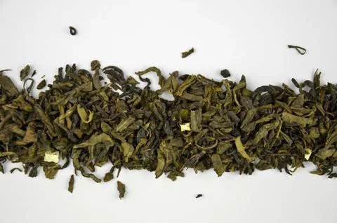 Dry green leaf tea aligned pile (line), closeup (macro) isolated, top view Stock Photos