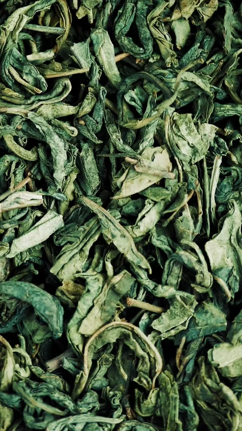 Dry green tea. close-up. rotation food. Uncooked and dried tea. twisted and Stock Footage 319901814