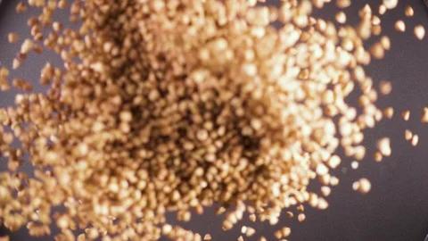 Dry groats fall down from under the camera slow motion Stock-Footage 90958809