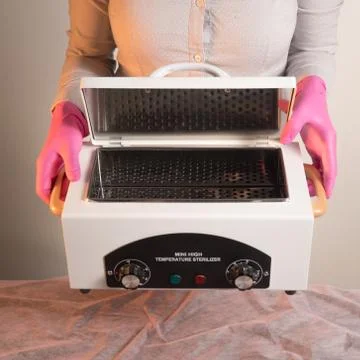 Dry heat for sterilization instruments in hands hold Stock Photos