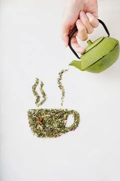 Dry herbal tea leaves in shape of cup Stock Photos