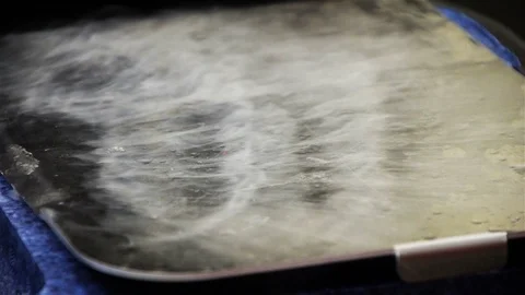 Dry ice billows over a cold plate Stock Footage 93471625