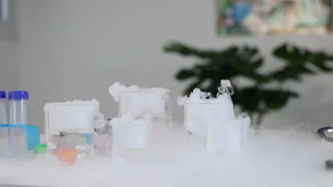 Dry Ice Sublimation Creating Thick White Smoke in Laboratory Glass Beakers Stock Footage 328619390