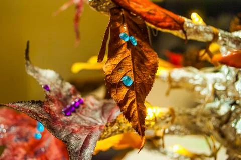 Dry leaf with plastic drops decoration close up. Stock Photos