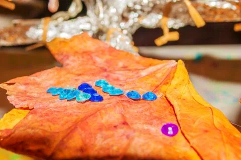 Dry leaf with plastic drops decoration close up. Stock Photos