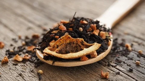 Dry leaves of black fruit tea with cinnamon, apple, orange, coriander Stock Footage 104977066