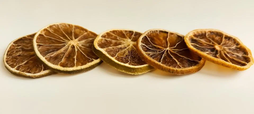Dry lemon wedges on white background Stock Photos