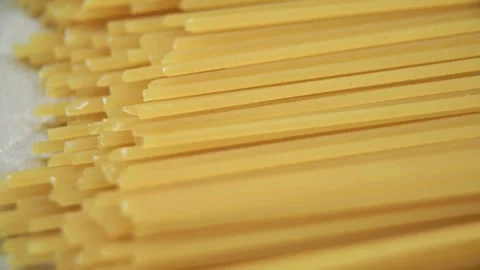 Dry long spaghetti pasta strands arranged in neat row Video stock 333833337