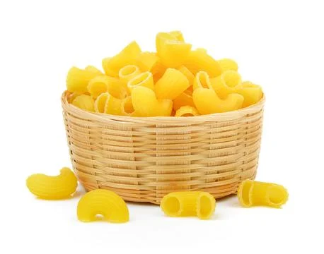Dry macaroni in the basket on white background Fotos de archivo