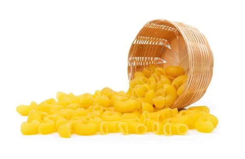 Dry macaroni in the basket on white background Fotos de archivo