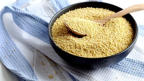 Dry millet in  bowl  Stock Footage 88963465