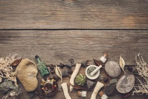 Dry moss, roots, nut shell, plants, infusion bottles and homeopathic globules. Stock Photos