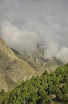 Dry mountain covered with clouds. Combination of dry mountain and green mountain Foto stock