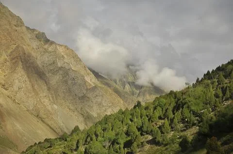 Dry mountain covered with clouds. Combination of dry mountain and green mountain Stock Photos