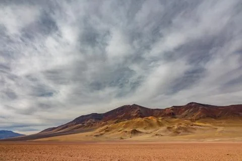 Dry mountains under the cloudscape in the desert Stock Photos