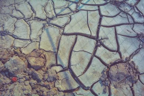 Dry mud ground, crack texture, granite gravel. Dry dirty soil. Cracks on clay Fotos Stock