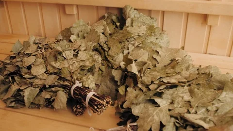 Dry oak broom for a bath close-up. Wooden Finnish sauna interior. scoops and Stock Footage 109601213