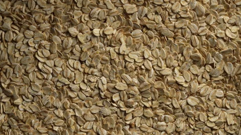 Dry oat flakes background, close up, rotation. Uncooked raw oat flakes grains Stock Footage 301653580