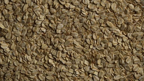 Dry oat flakes background, close up, rotation. Uncooked raw oat flakes grains Stock Footage 307384679
