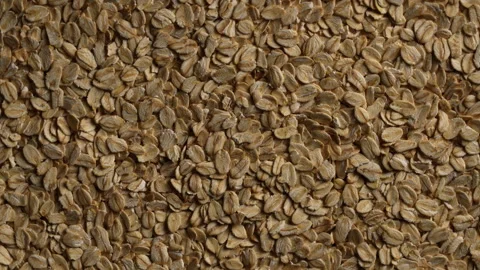 Dry oat flakes background, close up, rotation. Uncooked raw oat flakes grains Stock Footage 307954698
