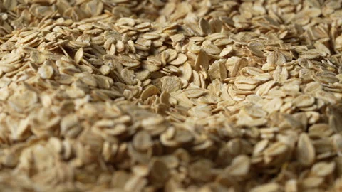 Dry oat flakes background, close up, rotation. Uncooked raw oat flakes grains 動画素材 331537022