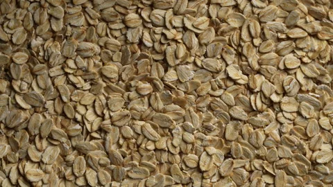 Dry oat flakes background, close up, rotation. Uncooked raw oat flakes grains Stock Footage 333240464