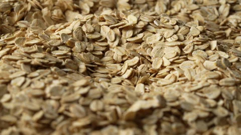 Dry oat flakes background, close up, rotation. Uncooked raw oat flakes grains Видео 334652189