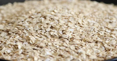 Dry oat flakes grains rotating on black background 6 Stock Footage 146992402