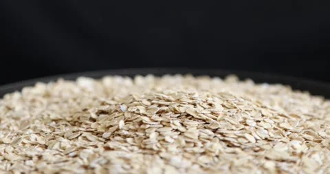 Dry oat flakes grains rotating on black background 7 動画素材 146993843