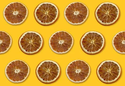 Dry orange fruit pattern on yellow background Foto stock