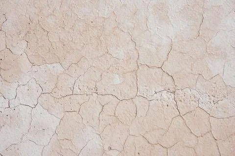 Dry pale sandy surface with cracks Stock Photos