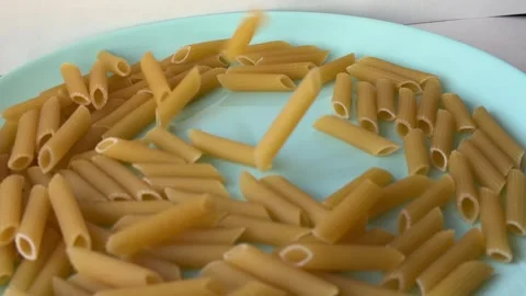 Dry pasta falling and dropping repeatedly making hollow clattering sounds Vídeos de archivo 328704946