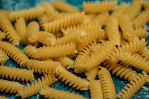 Dry pasta on rustic blue background Stock Photos