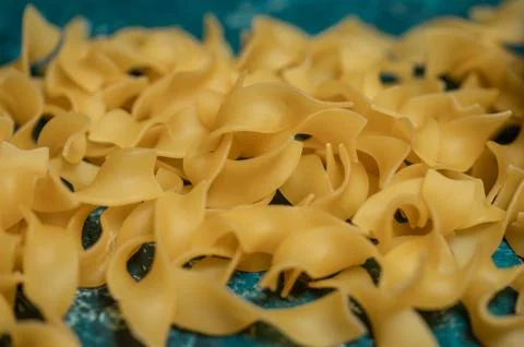 Dry pasta on rustic blue background Stock Photos