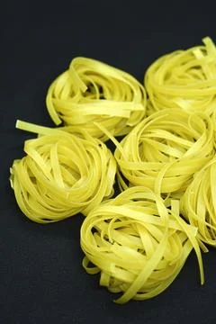 Dry paste on a black background. Wheat pasta. 스톡 사진