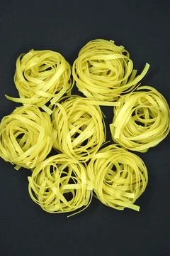 Dry paste on a black background. Wheat pasta. 스톡 사진