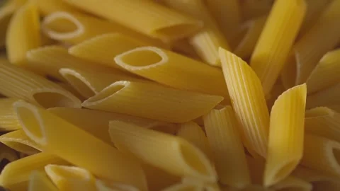Dry Penne Pasta in Ceramic Bowl on Kitchen Counter Tilt-Up Shot Stock Footage 314599208