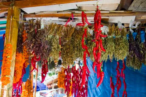 Dry pepper and other paces hanging in the outdoor market Stock Photos