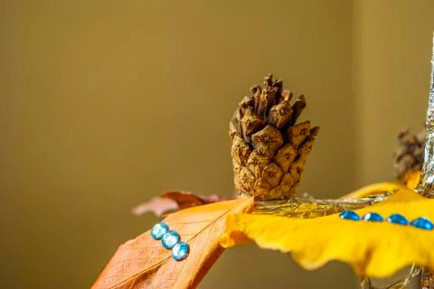Dry pine cone and multi color leaves christmas tree natural decoration closeup. Stock Photos