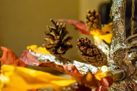 Dry pine cone and multi color leaves christmas tree natural decoration closeup. 스톡 사진
